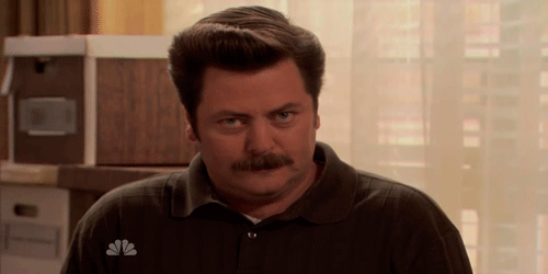 GIF showing a man with a mustache staring at the camera